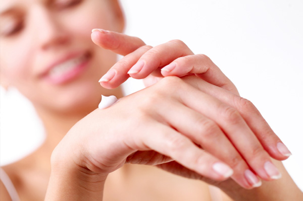 woman-applying-hand-cream-winter